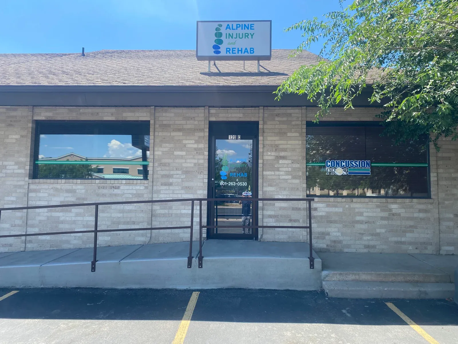 The Clearfield clinic at 120 S. State Street, Suite C, with Alpine Injury & Rehab and Concussion Pros signs.